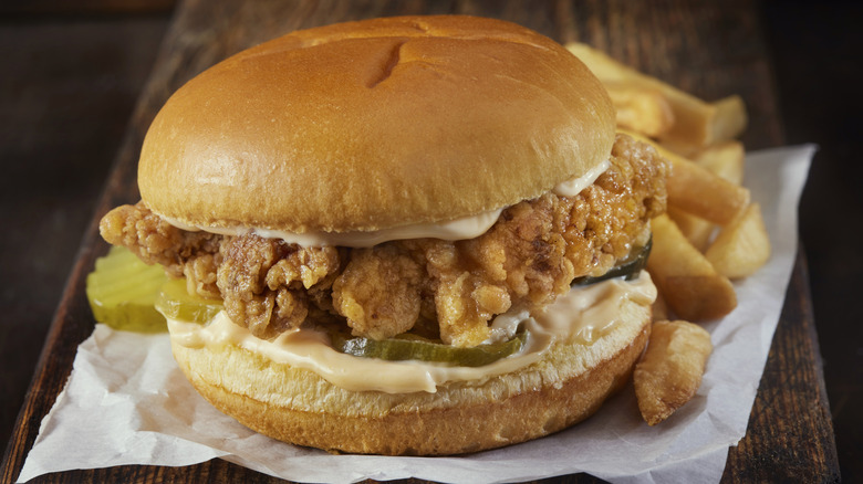 A fried chicken sandwich with french fries