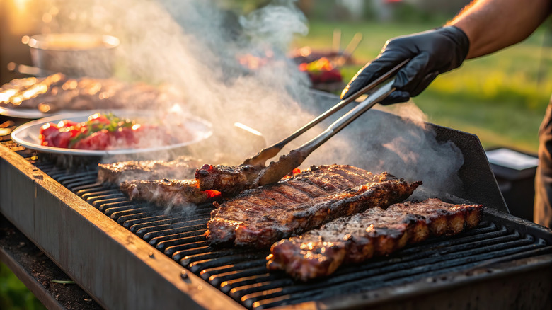 A grill with meats and vegetables cooking
