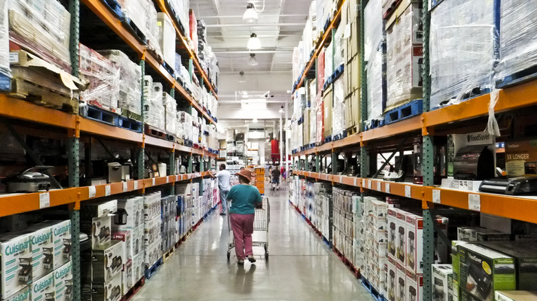 Customer walking through a Costco aisle