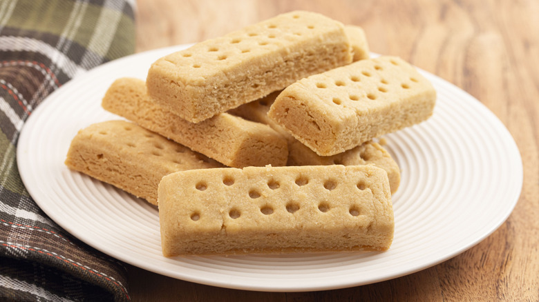 Classic shortbread cookies on a plate next to tartan