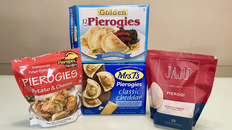 Several types of frozen pierogies in their packages, neatly laid out and stacked on a table