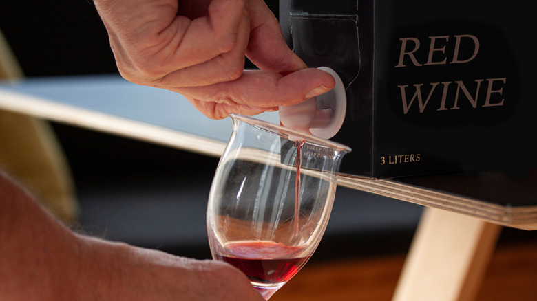 Pouring boxed red wine into a glass