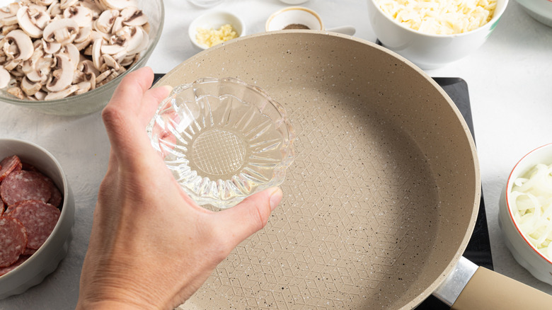Adding oil to pan